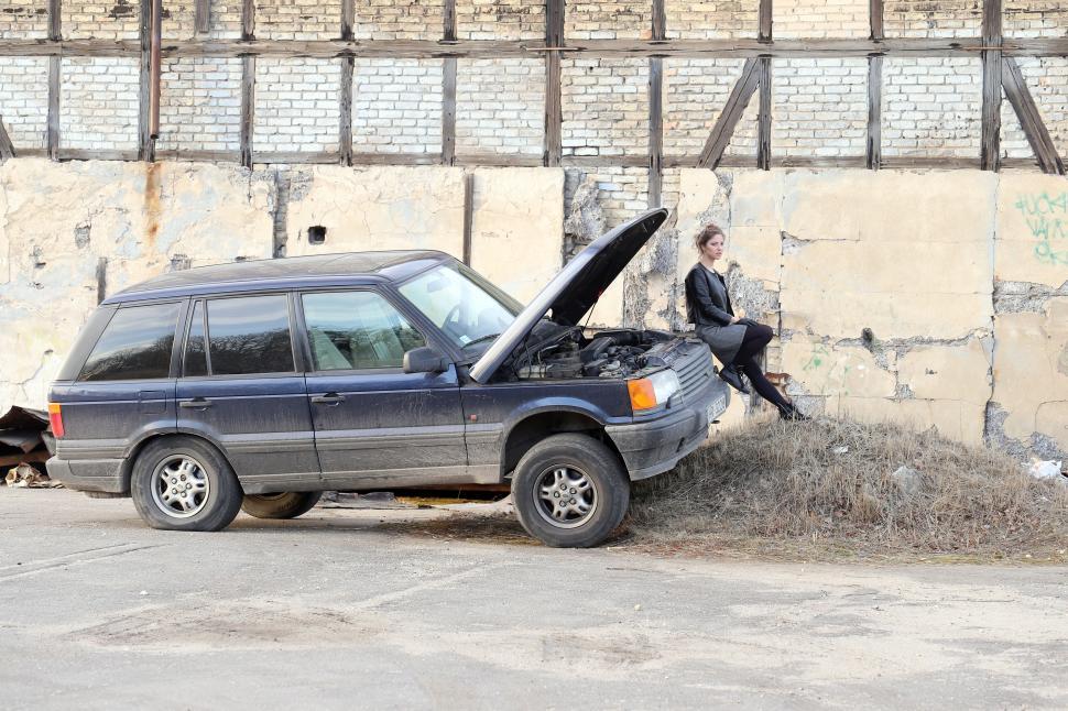 Free Image of Woman waiting for a mechanic with car 