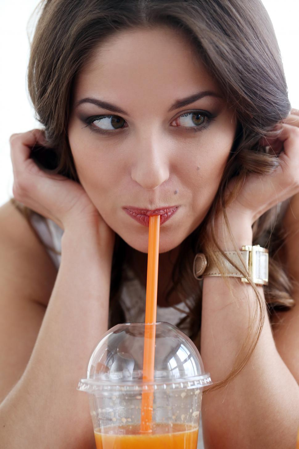 Free Image of Beautiful girl drinking fresh orange juice 