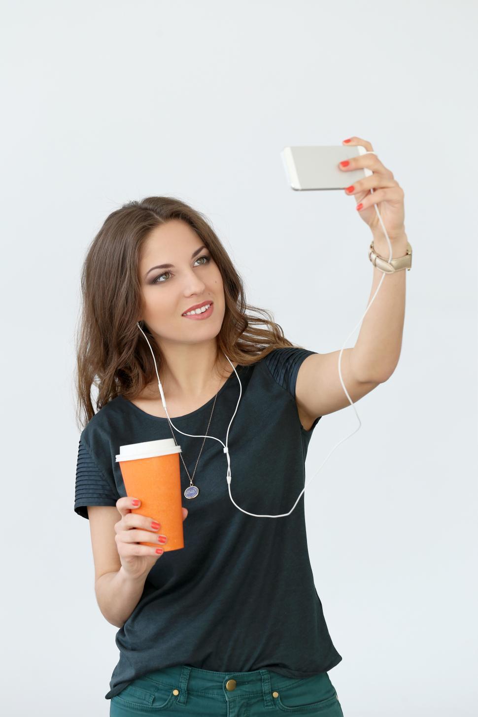 Free Image of Curly girl with mobile phone taking selfie 