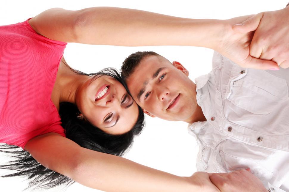Free Image of young happy couple putting their heads together 