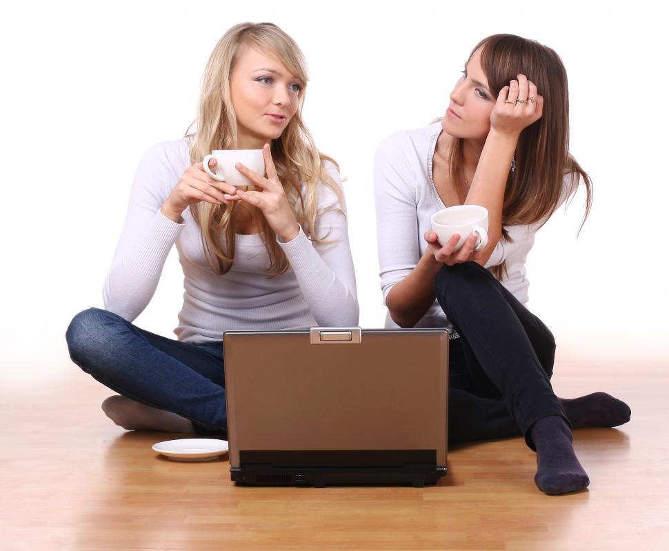 Free Image of group of two beautiful sisters sitting with coffee 