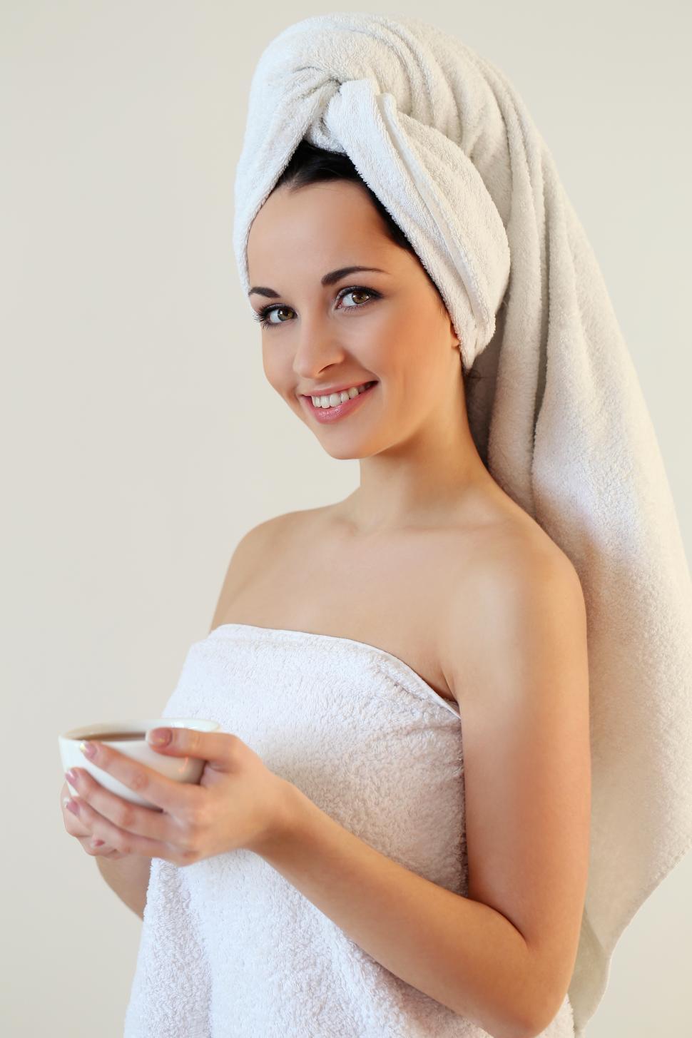 Woman in towel with a cup of coffee