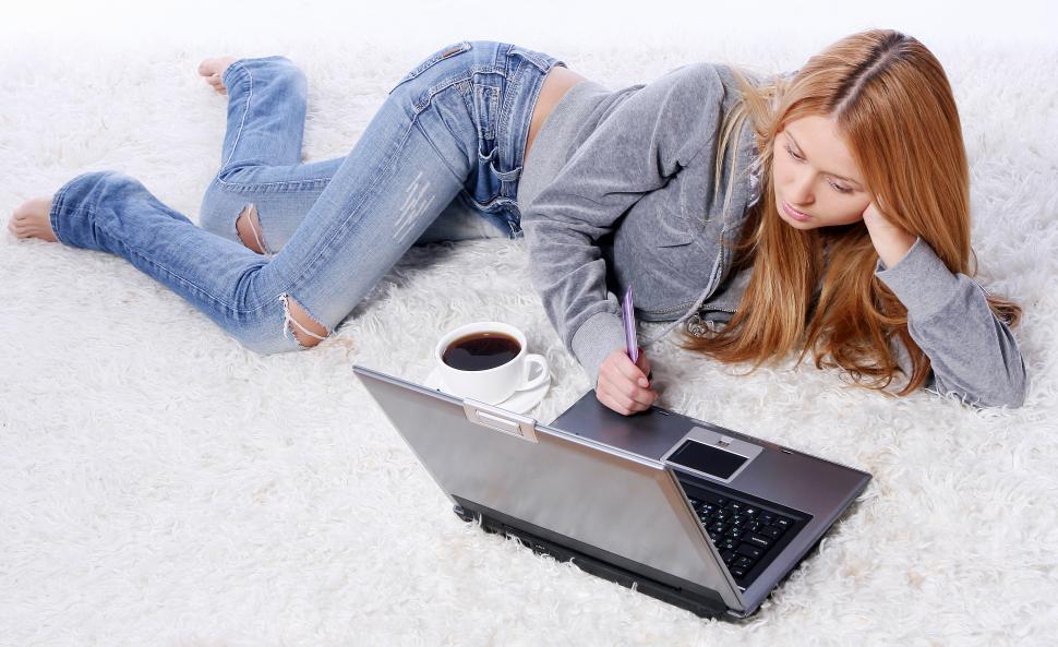 Free Image of happy smiling young girl in room with coffee and laptop 