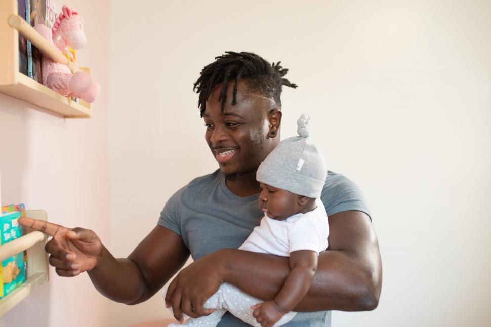 Free Image of Young Father and Little Baby With baby bookshelf 