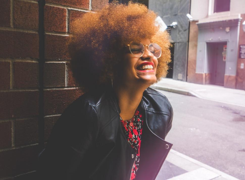 Free Stock Photo of Young Woman Leaning Against a Wall