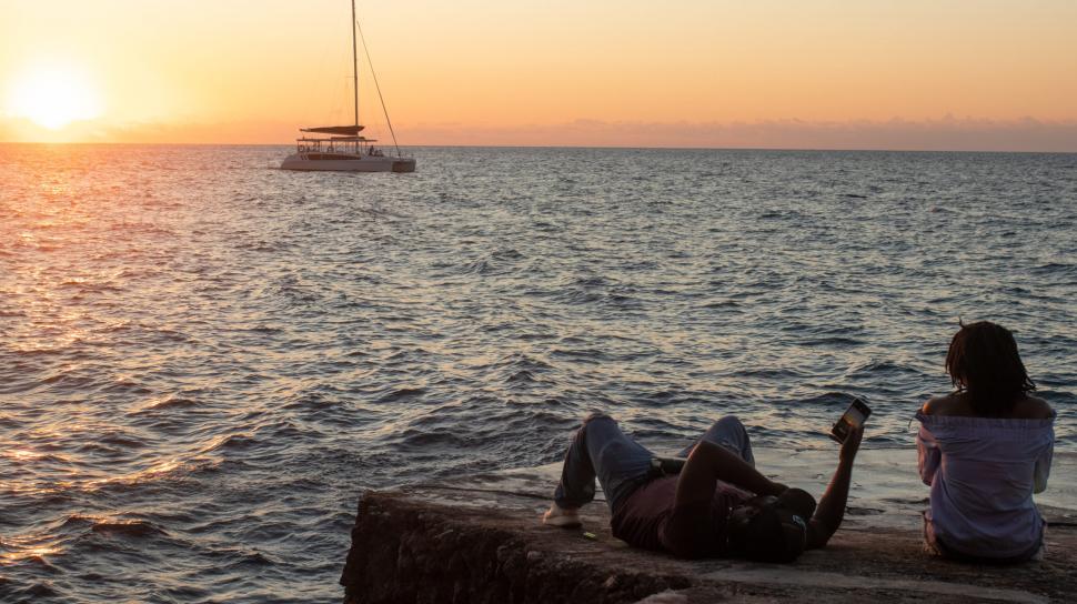 https://freerangestock.com/sample/138795/silhouette-view-of-man-and-woman-relaxing-at-seashore.jpg