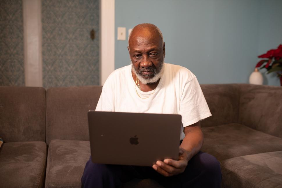 Free Image of Man with laptop at home, working on the couch 