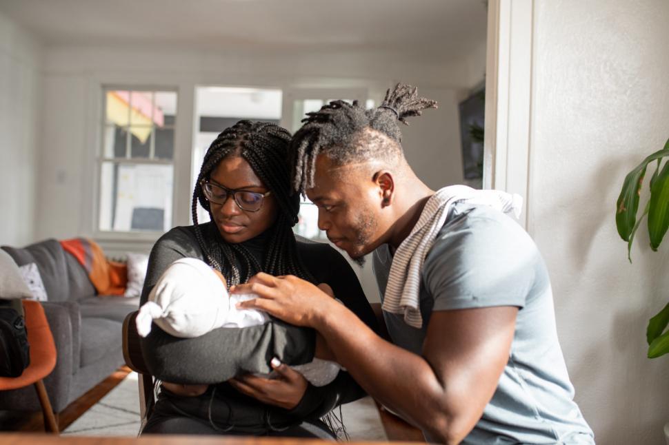 Young Couple With Newborn Baby at home
