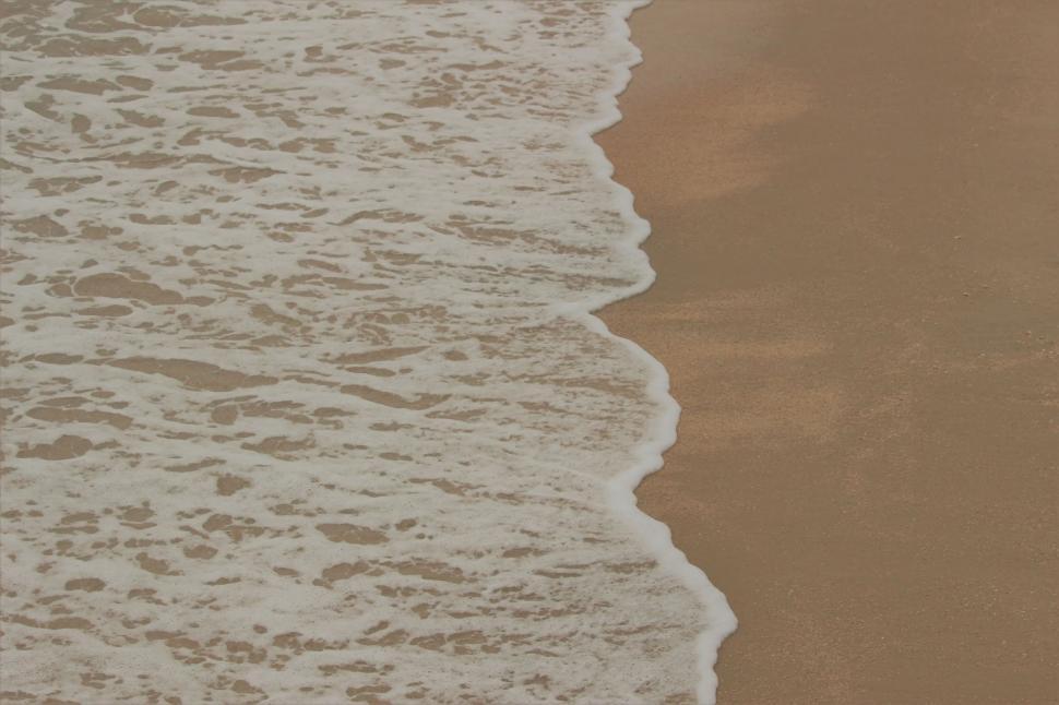 Free Image of Ocean wave washing up on a beach  