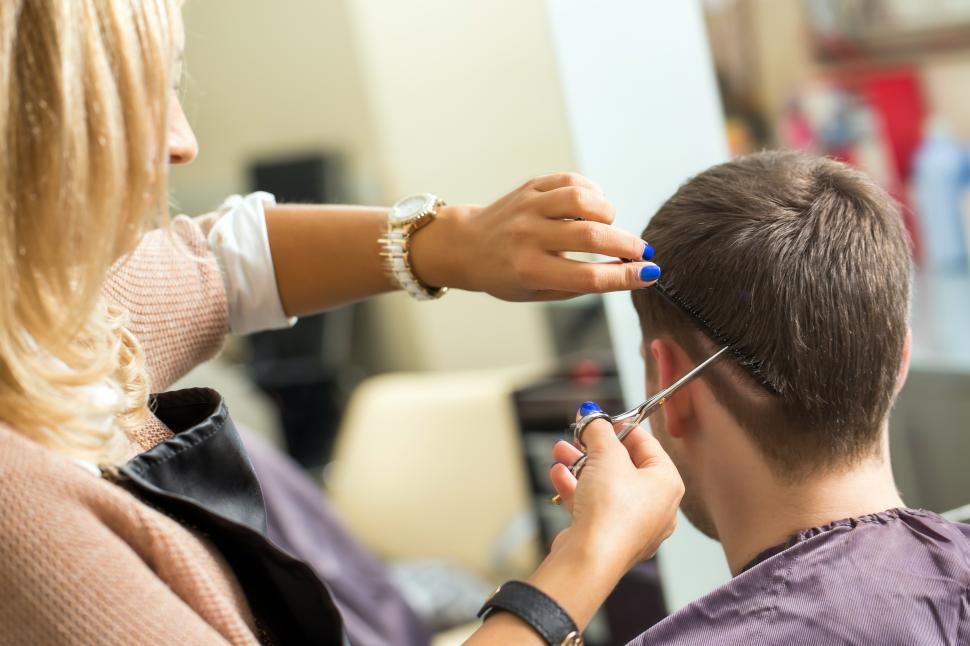 Free Image of Woman giving man a haircut 