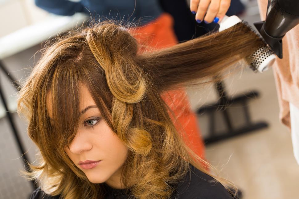 Free Image of Beauty, hairstyle. Hairdresser curling hair 