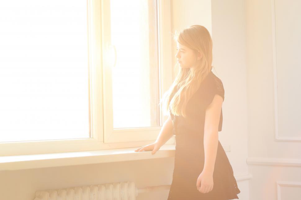 Free Image of Teenager at home with bright window wash 
