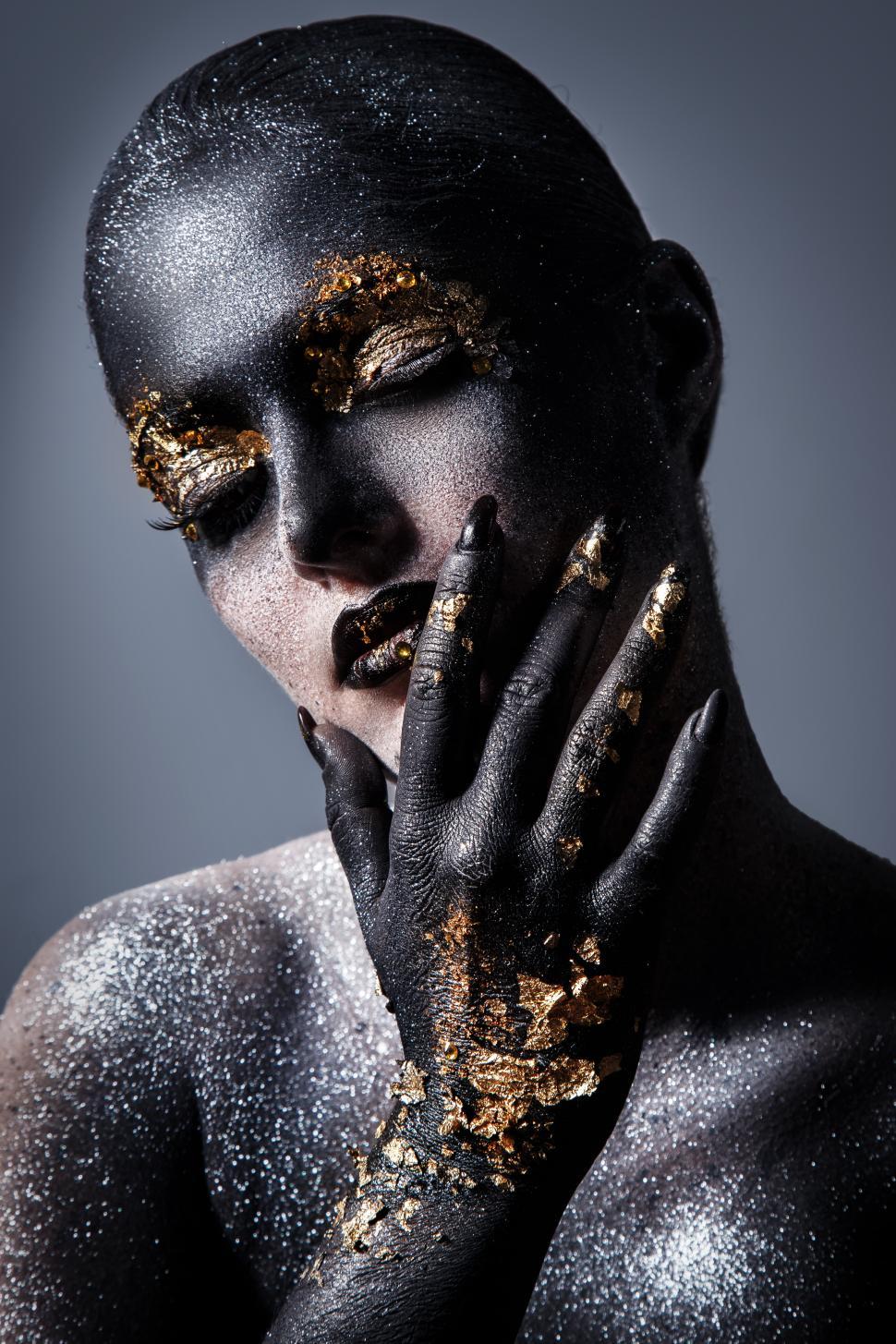 Stunning Picture of a Woman with Gold Body Paint and a Serious