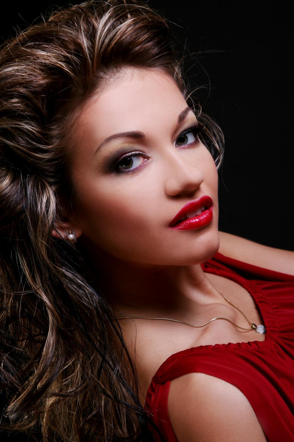Free Image of Young woman in red looking at camera - close up 