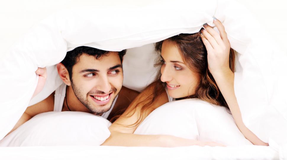 young-couple-under-the-covers-together.jpg