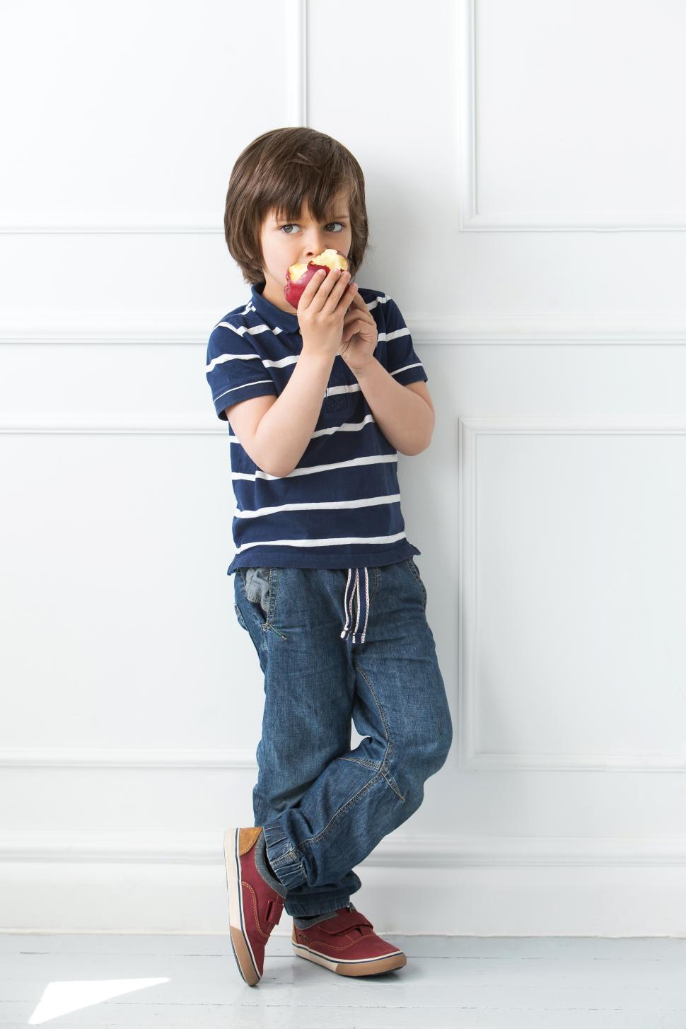 Free Stock Photo of Adorable kid standing and eating apple | Download ...