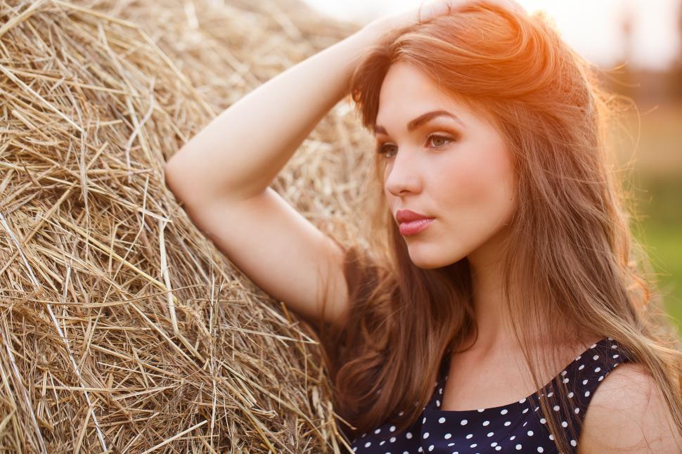 Free Image of Young woman in a hay field 