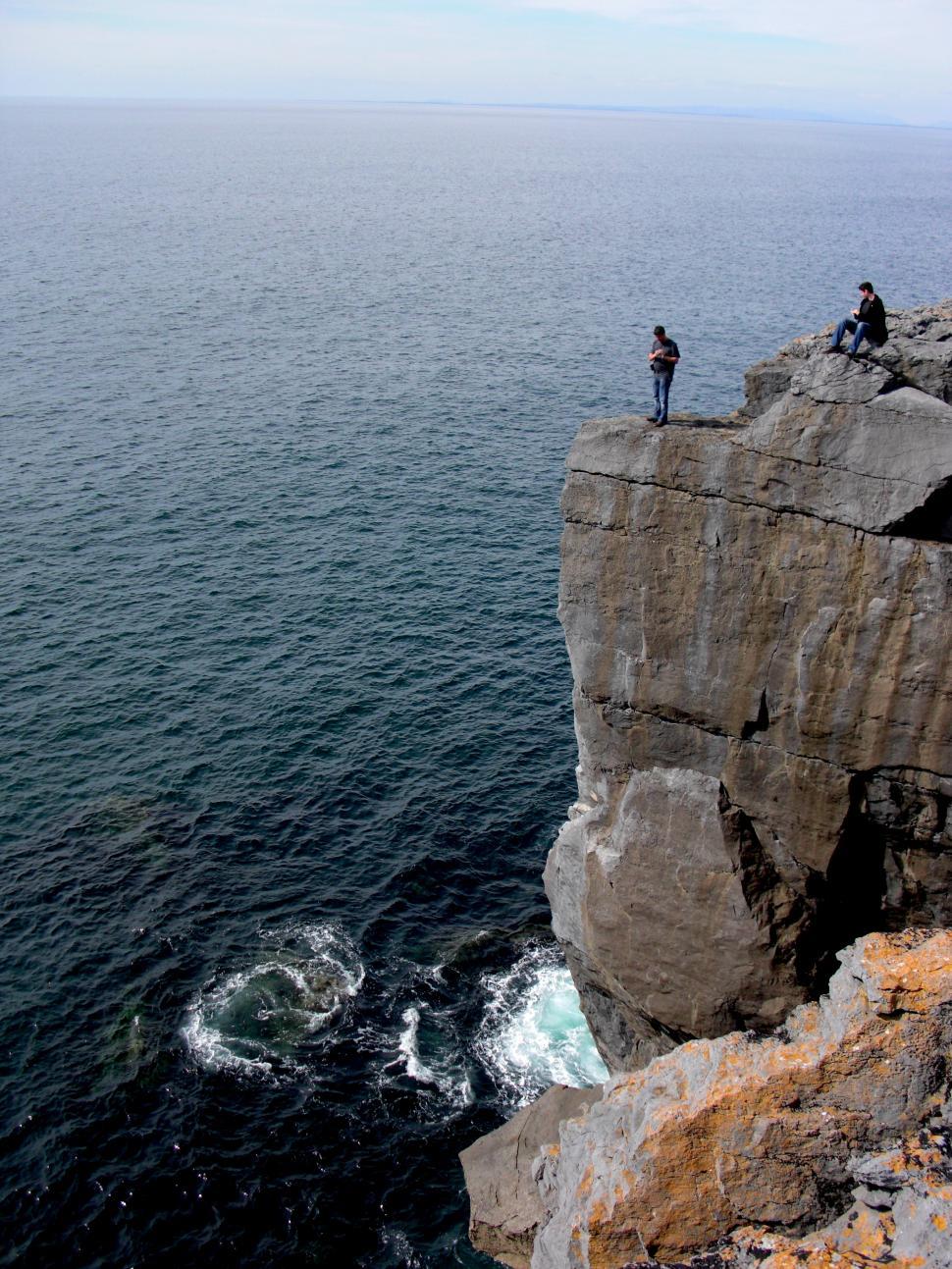 Free Stock Photo of Couple Standing on Cliff Overlooking Ocean ...