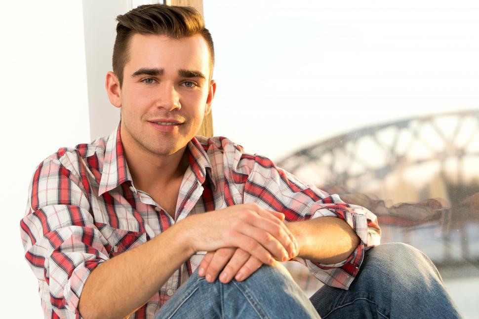 Free Image of Guy by the window, looking at the camera 