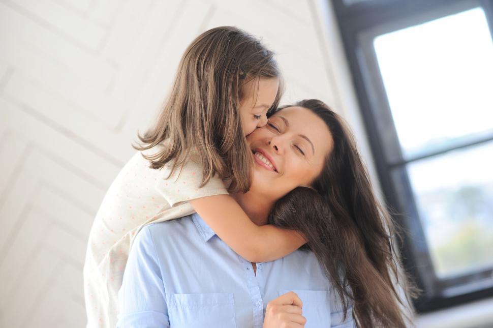 Free Image of Mother being hugged by daughter 