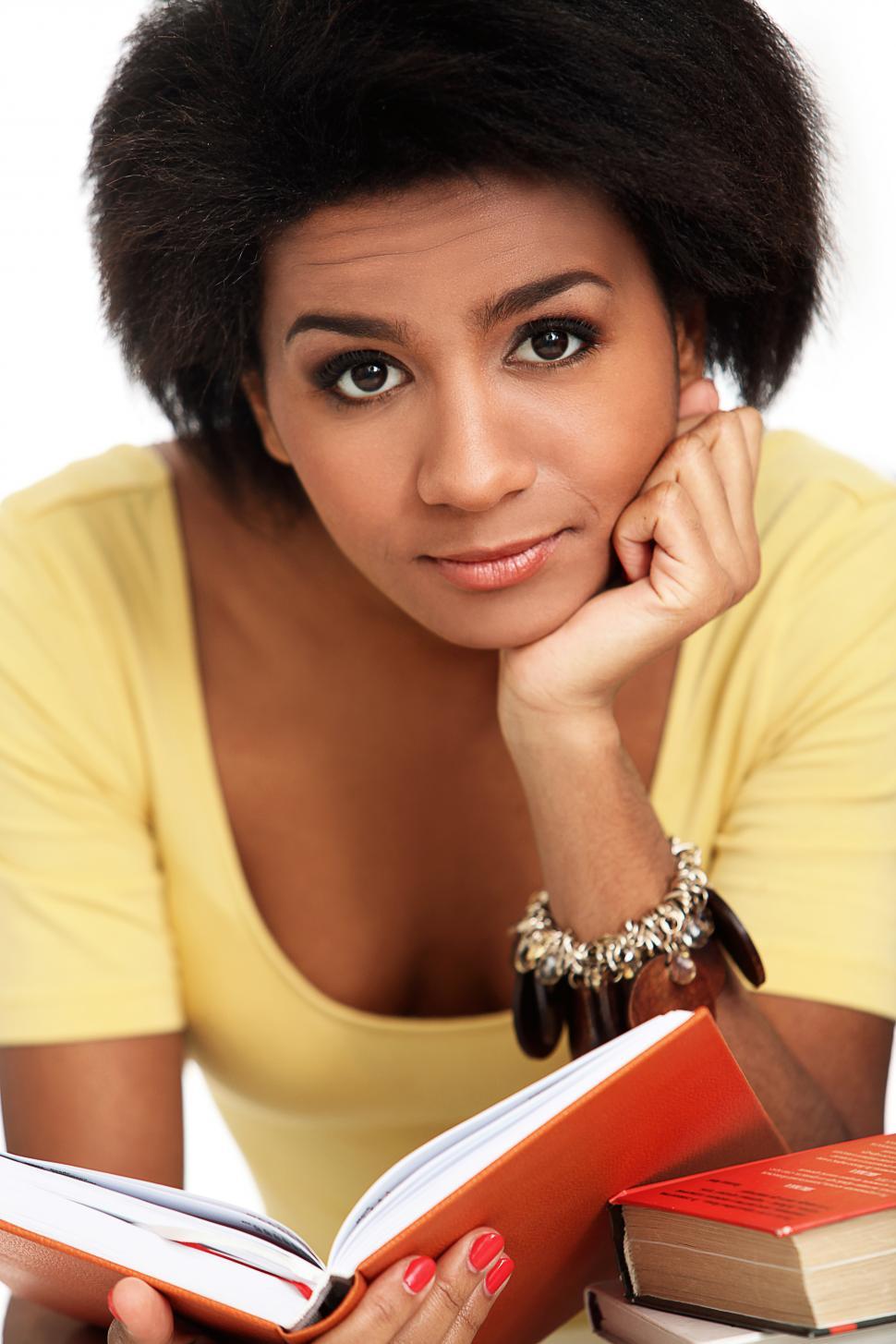 Free Image of Young woman casually reading a book 