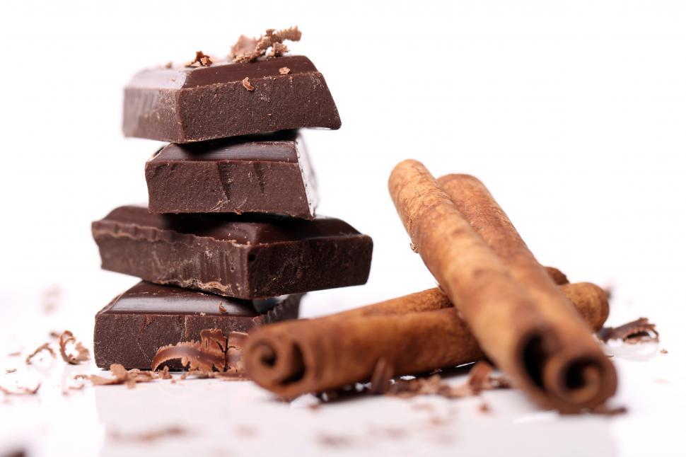 Free Stock Photo of Sacked chunks of chocolate with cinnamon sticks