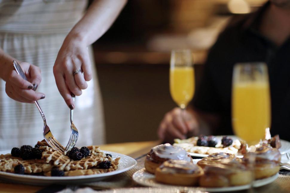 Free Image of Female hands and two forks with waffle 