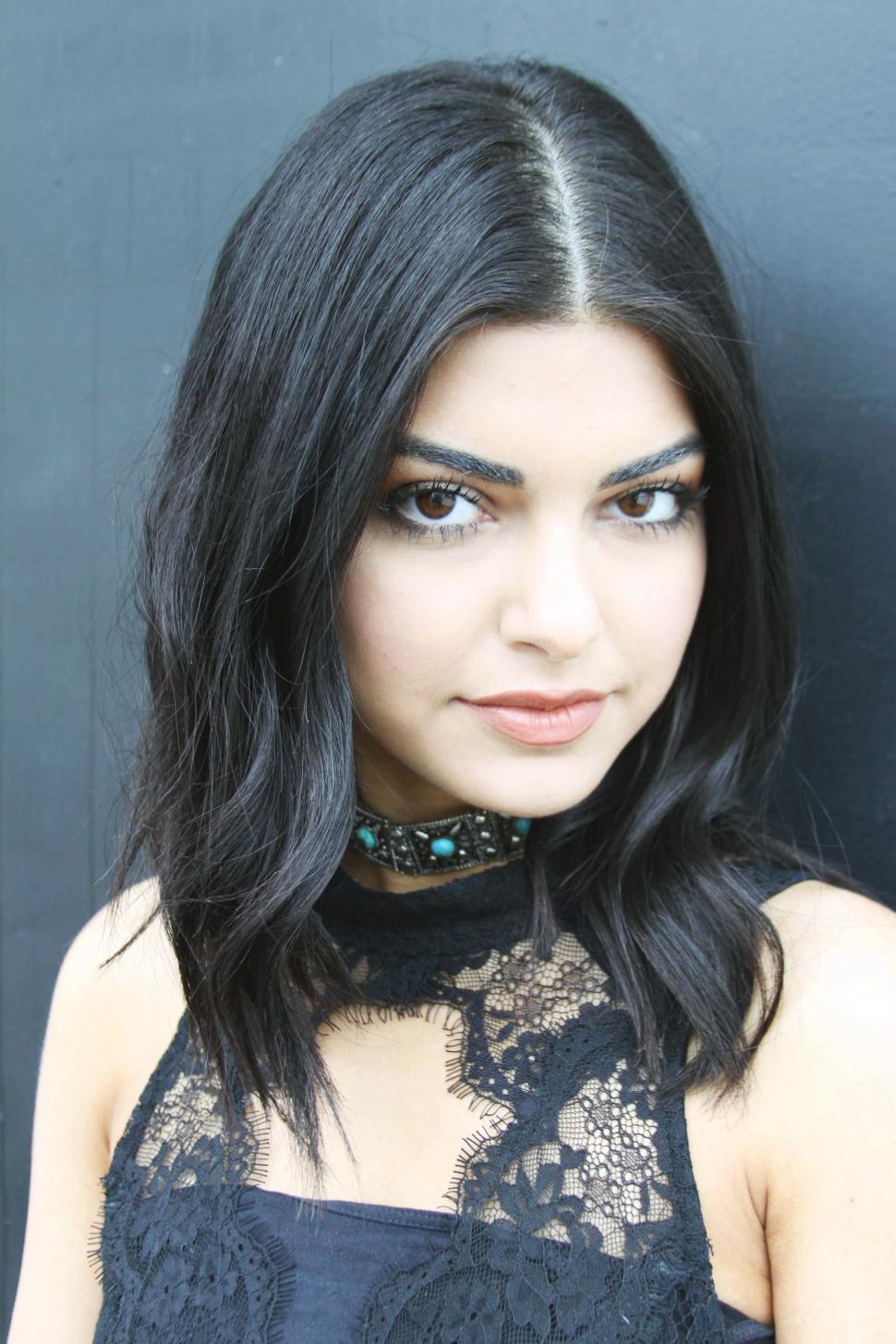 Free Image of Female fashion model posing in black dress 