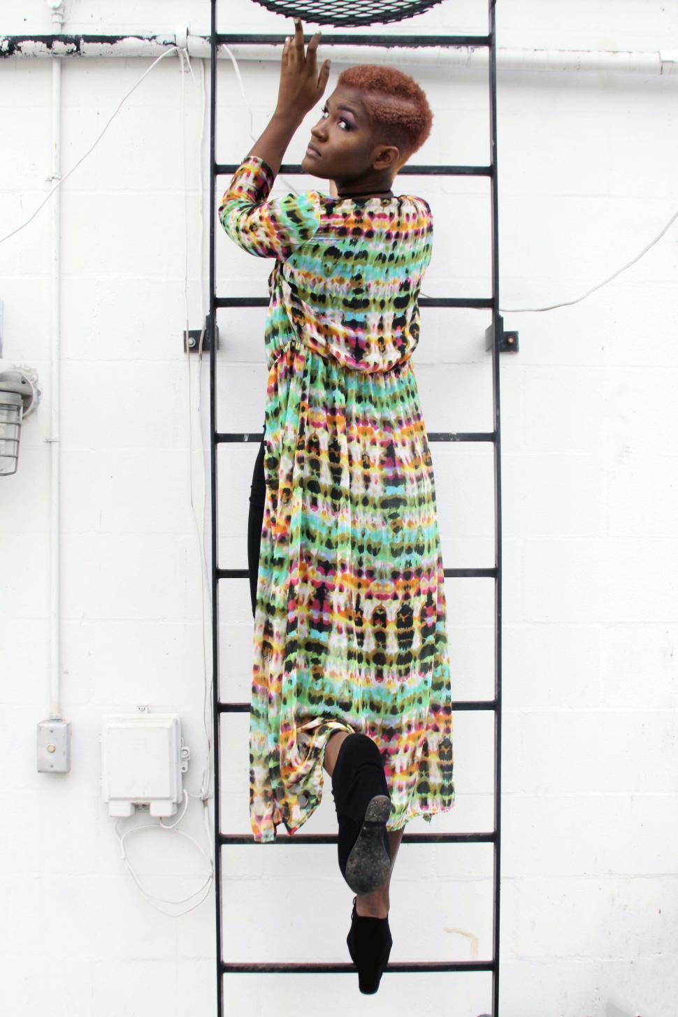 Free Image of Female fashion model posing on ladder - looking at camera 