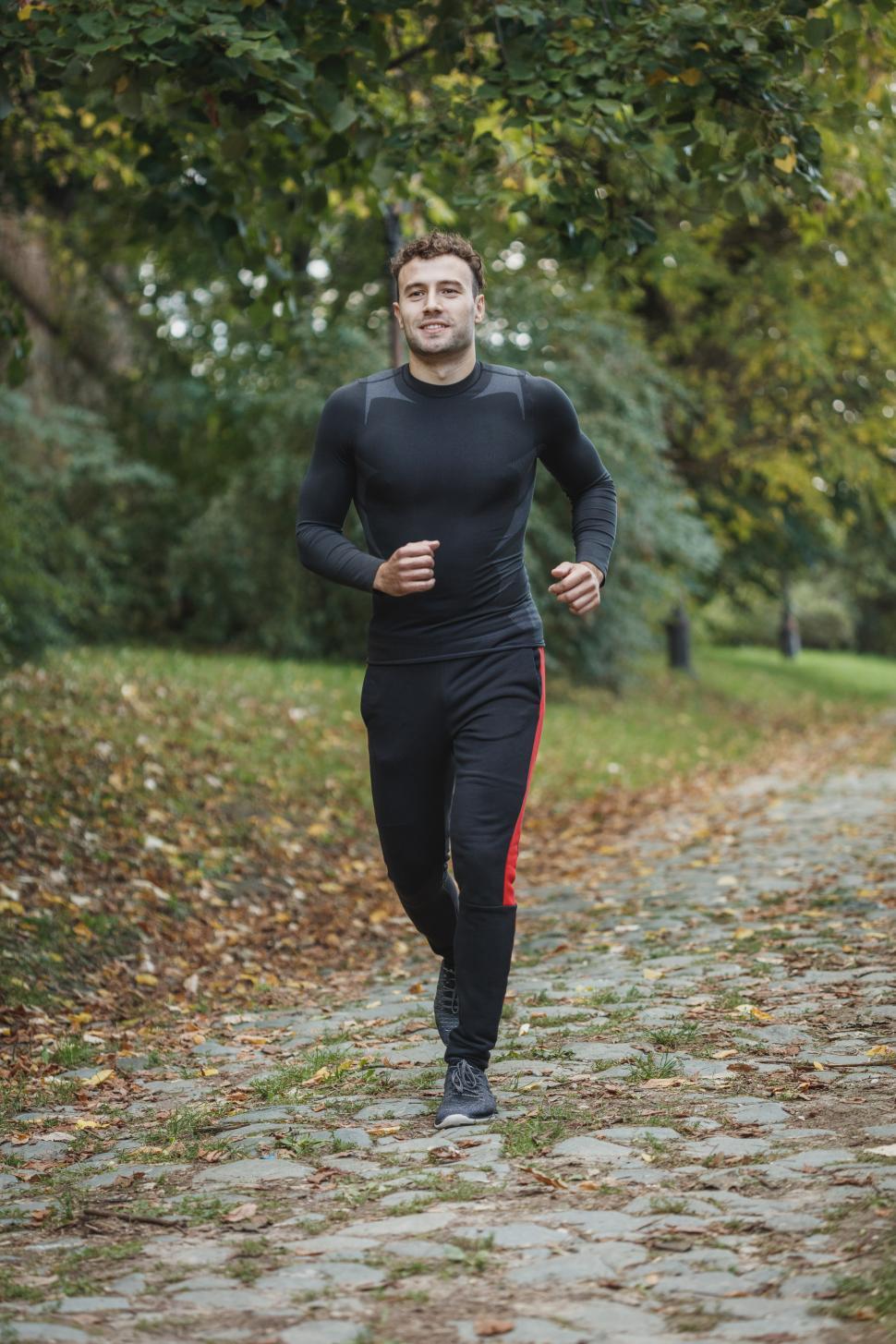 Sporty man jogging in a park stock photo