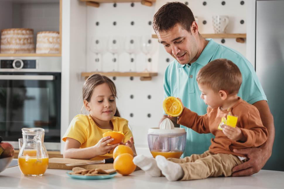 Free Stock Photo of Happy family making fresh orange juice at home