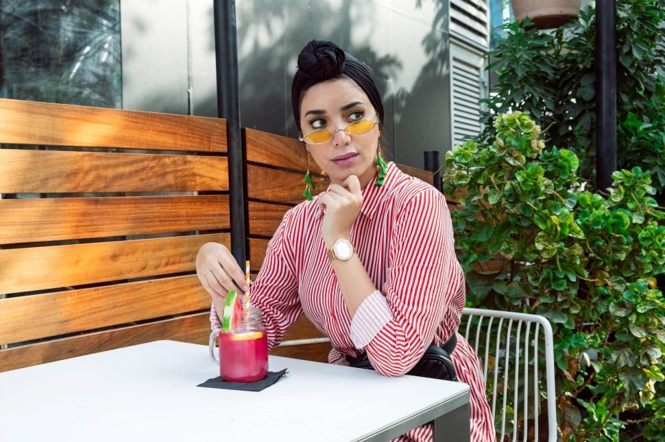 Free Image of Female fashion model in yellow sunglasses with mason jar and str 