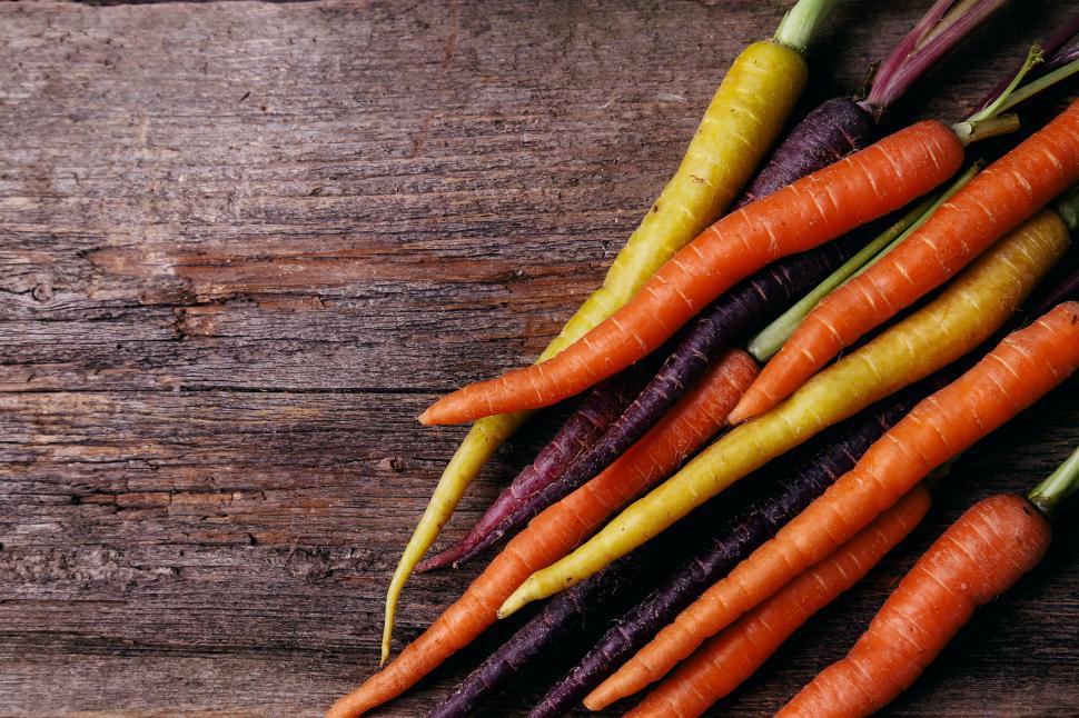 Free Image of Carrots on the dark wooden table 