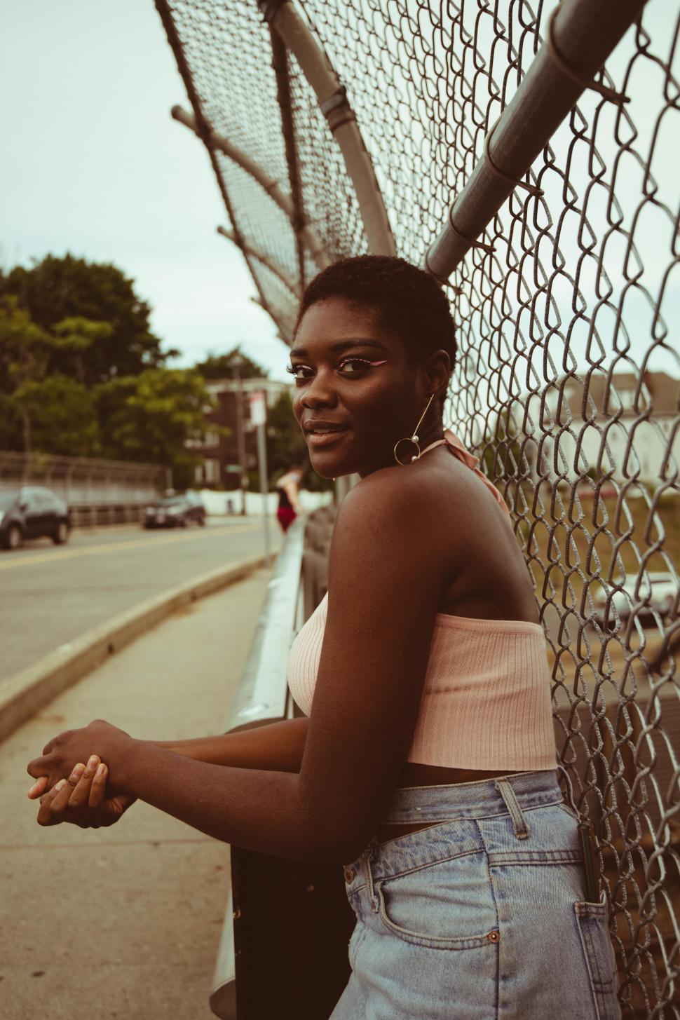 Free Image of Young stylish woman in denim shorts on the street - eye contact 