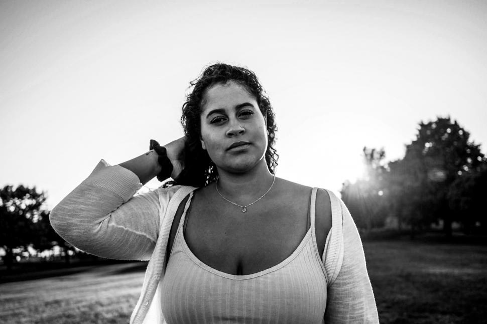 Free Image of Female fashion model with hand in hair in the park - b&w 