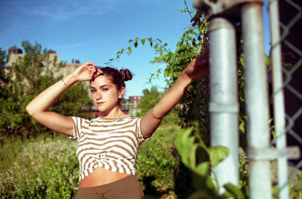 Free Image of Woman posing with fence - looking at camera 