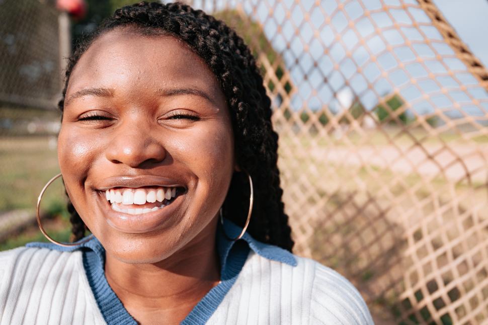 Free Image of Smiling Woman with hoop earrings 