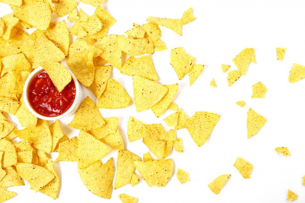 Free Stock Photo of Tortilla Chips scattered across a white background
