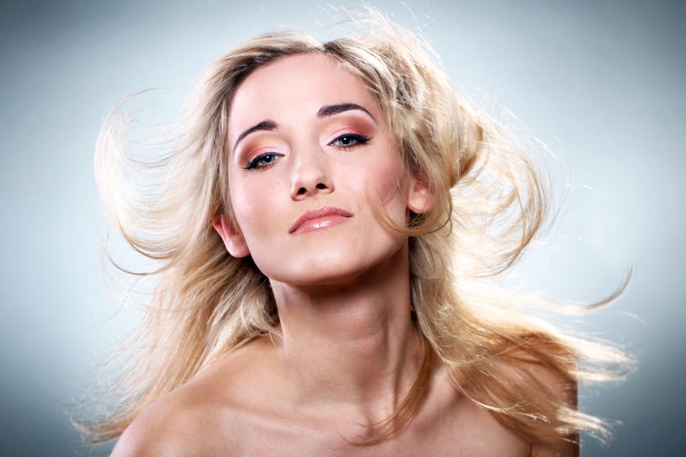Free Image of Young woman with hair flying, studio shot 