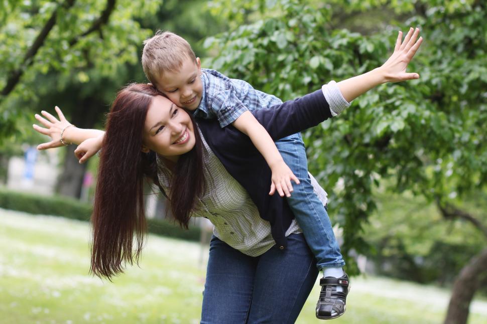 Young and happy mother playing with her son