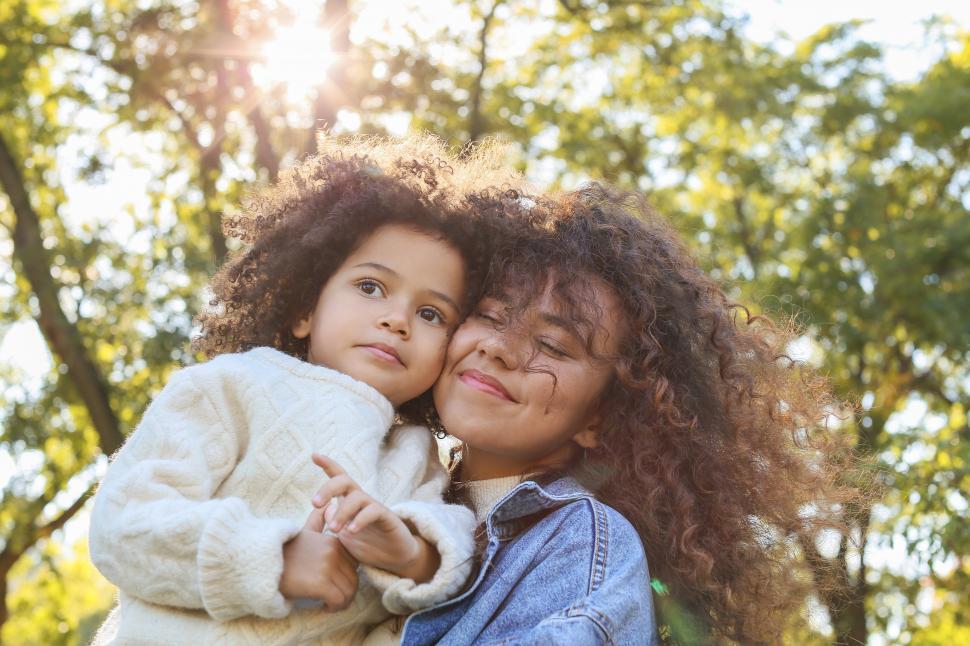 Free Stock Photo of Young smiling woman with eyes closed holding little ...