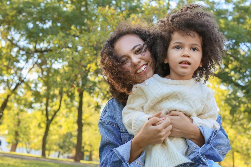 Free Stock Photo of Young smiling woman holding little girl in the park ...