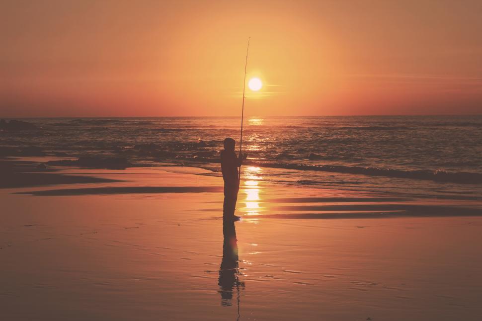 Free Stock Photo of Man with fishing rod at the beach during