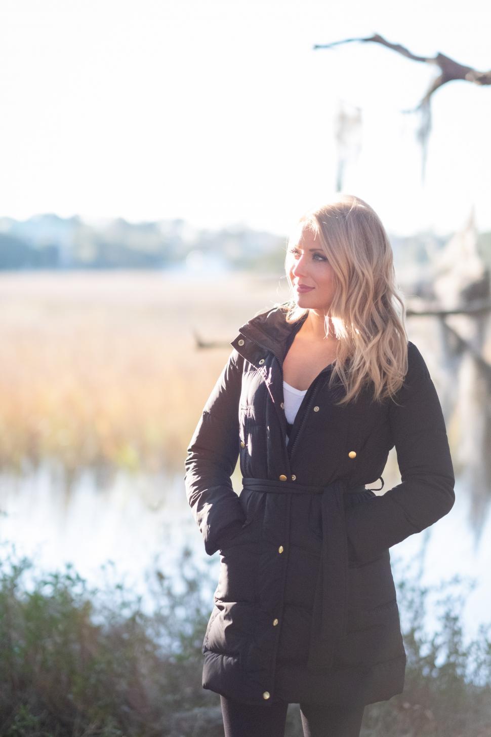 Free Image of Smiling blonde woman posing at the coastline 