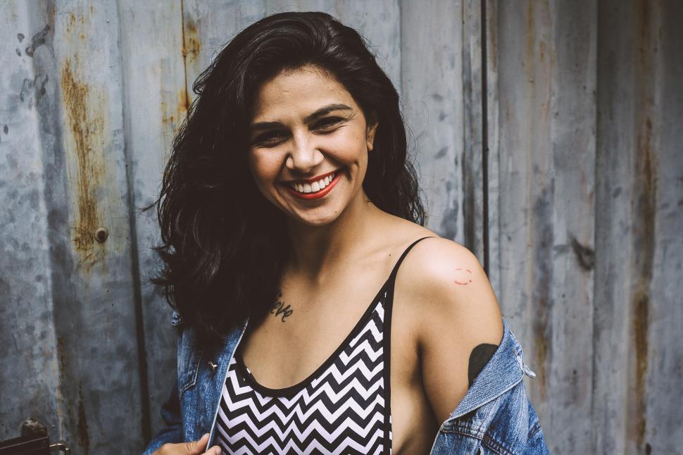 Free Image of Woman with open denim shirt, posing for camera 