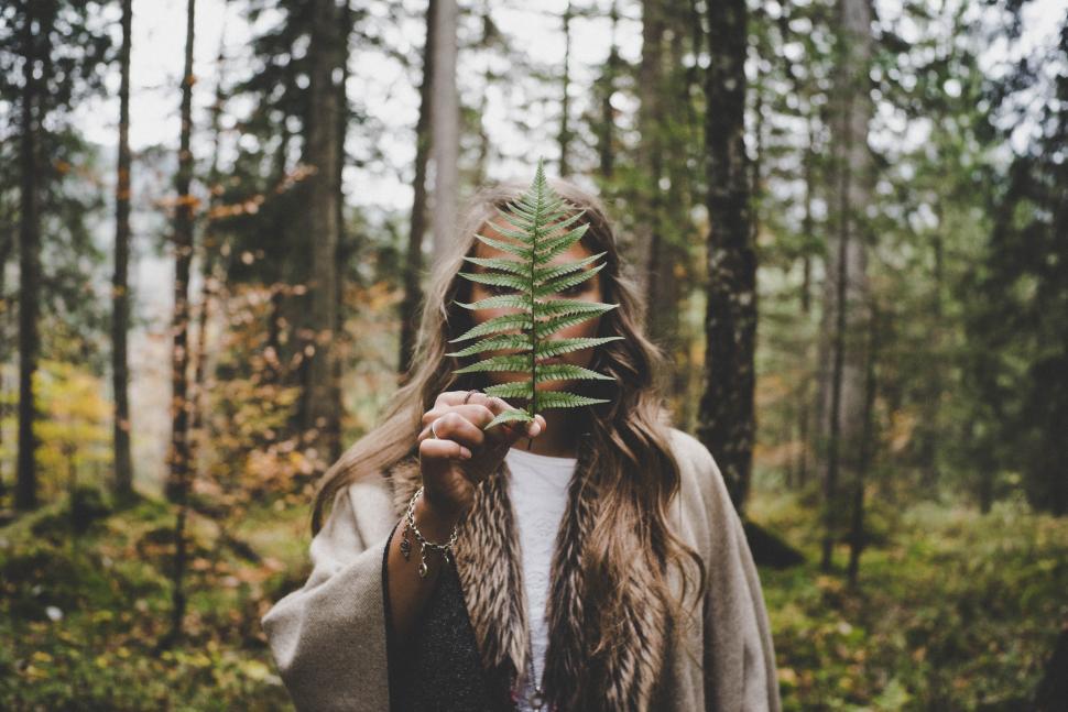 Free Image of Woman standing with fern leaf 