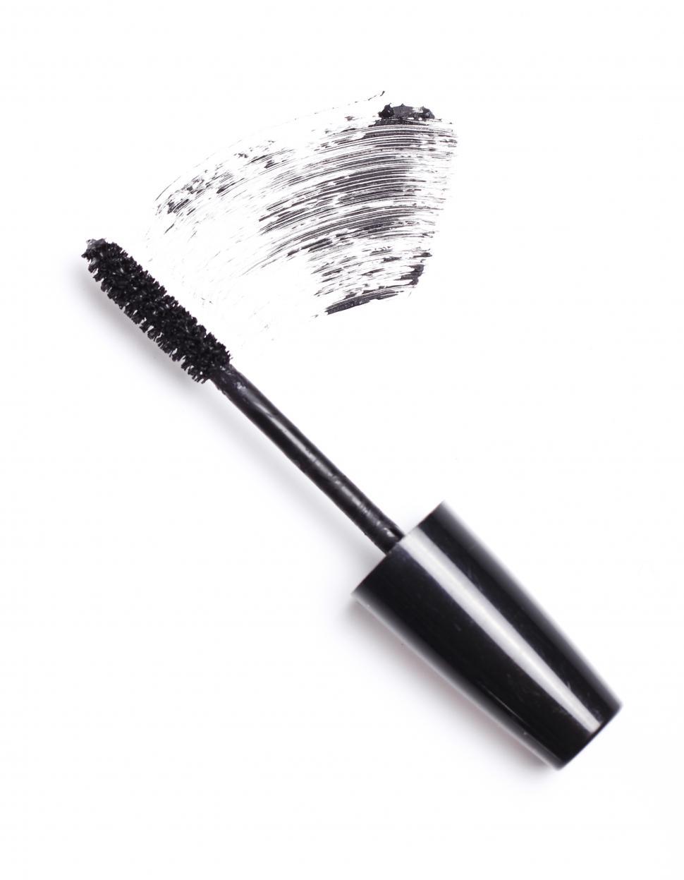 Free Image of Brush of black mascara for eyes smudged on white surface 