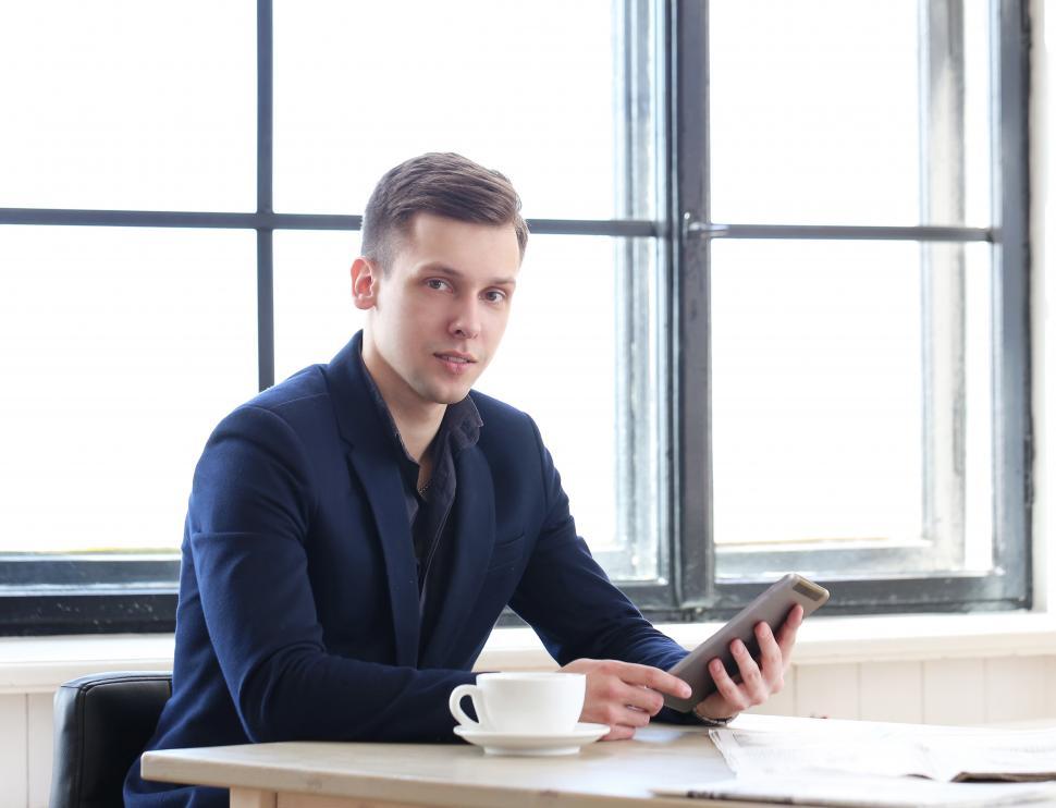 Free Image of Business man with small tablet device 
