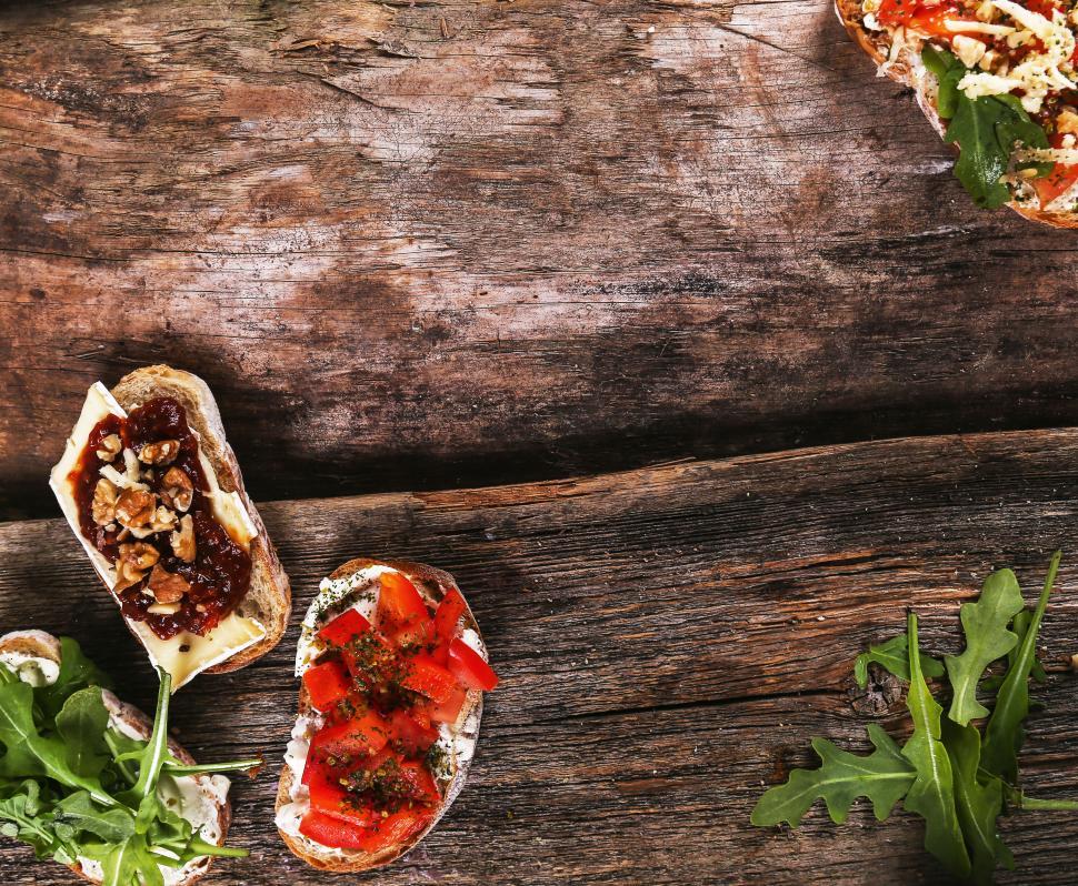 Free Image of Bruschetta on textured wood 