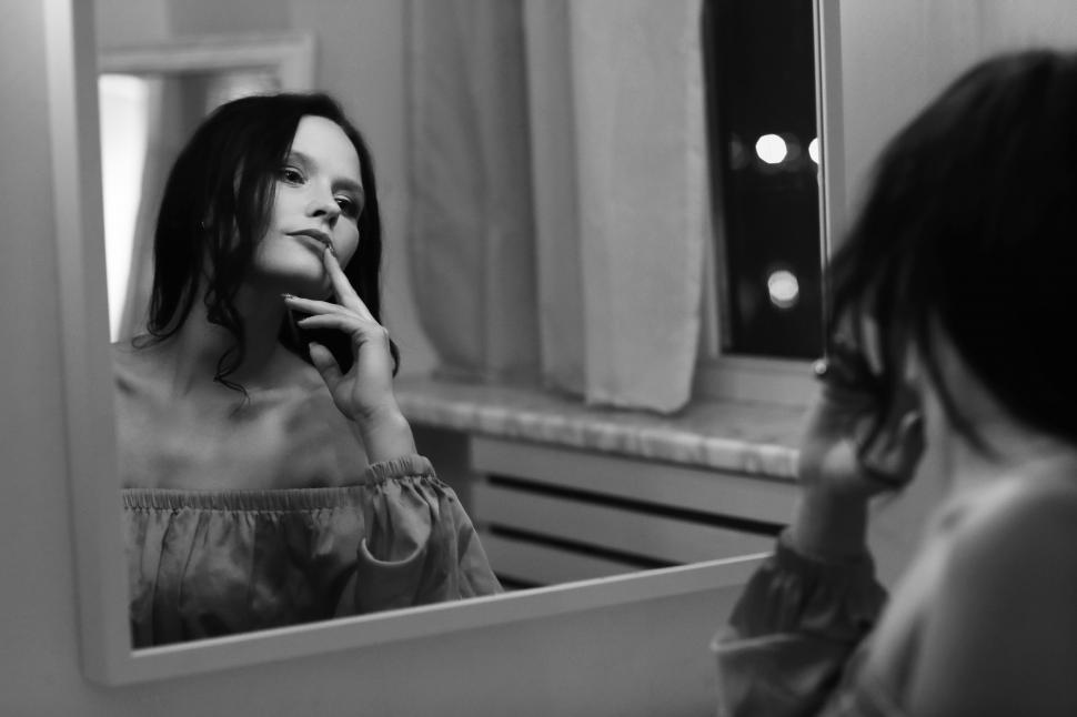 Free Image of Woman looking in mirror 